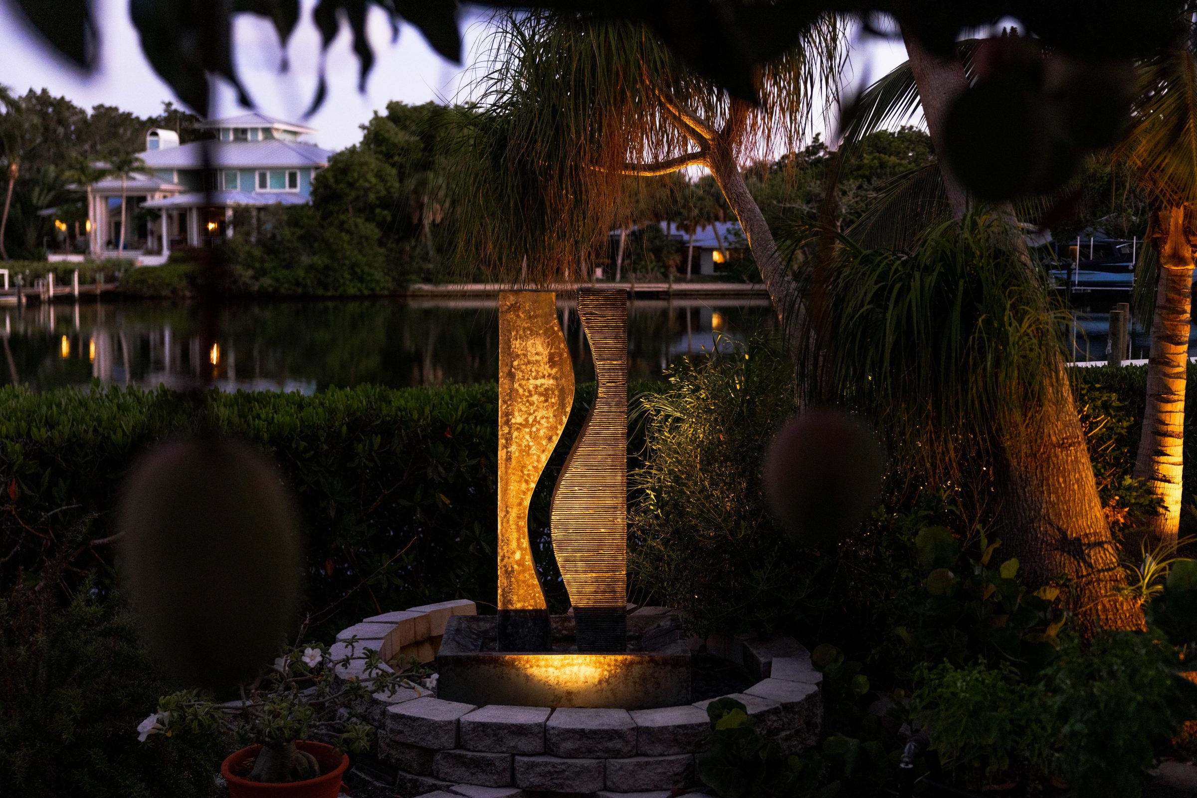Modern water feature illuminated in garden