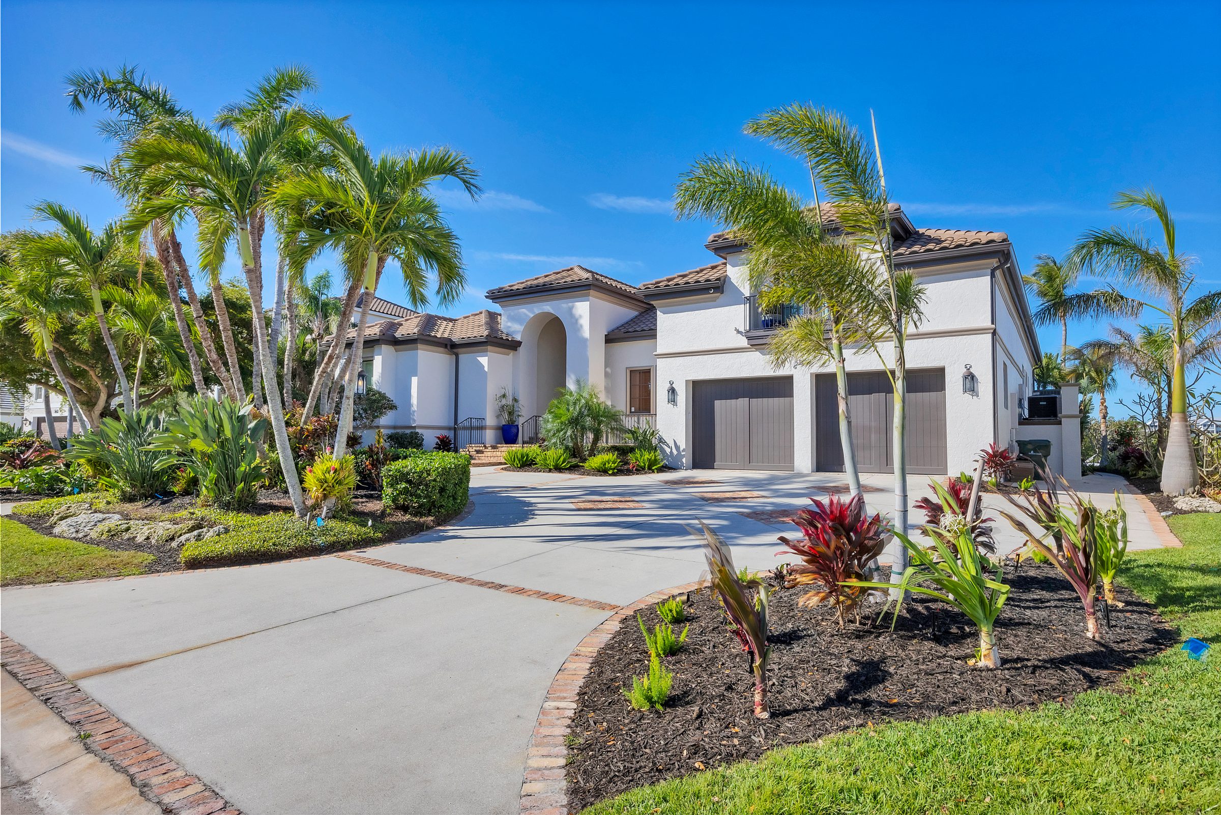 Front view of a Mediterranean-style home with a tan tile roof