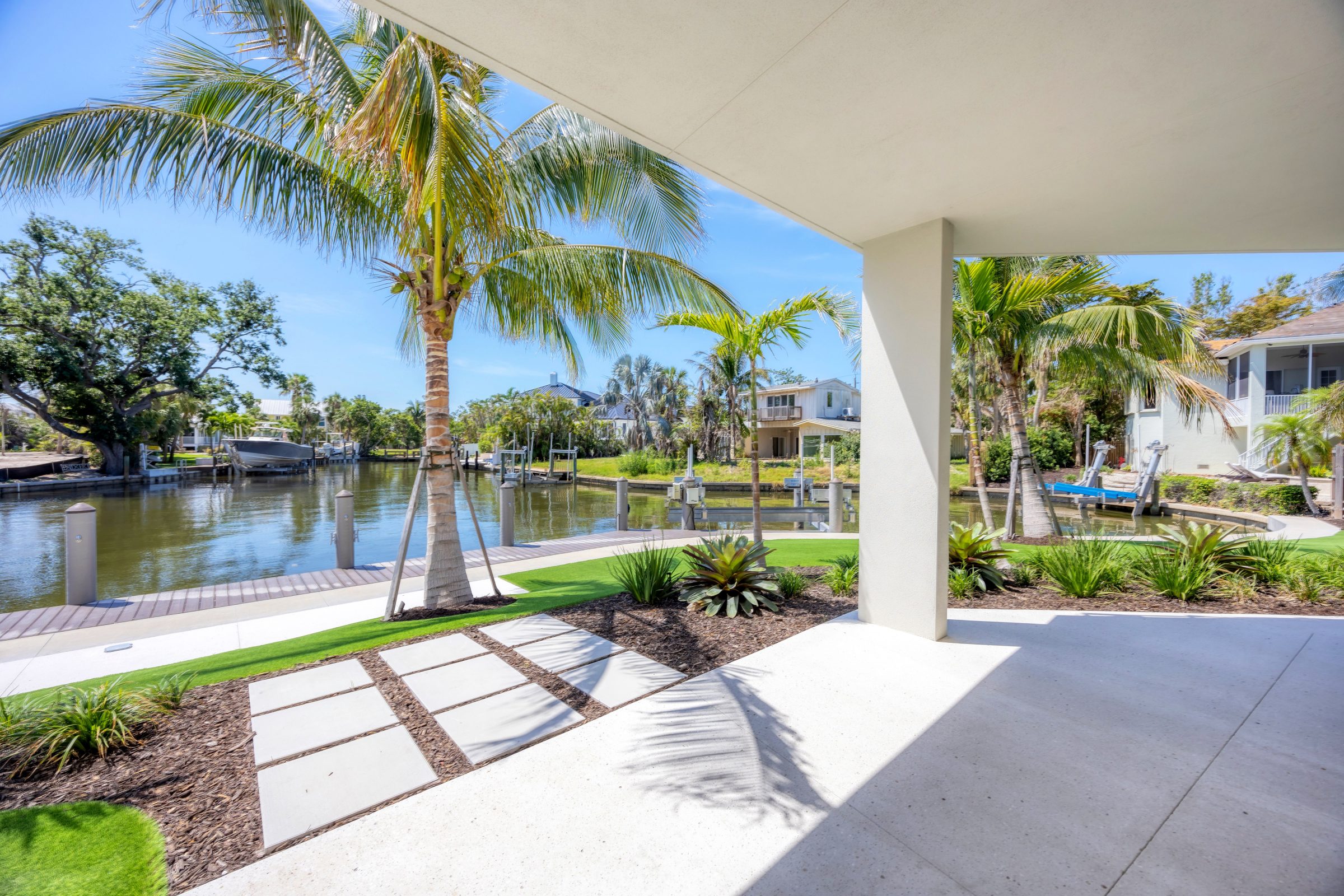 Covered patio overlooking canal and dock.